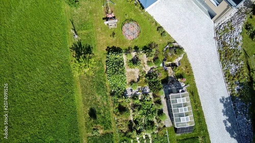 Aerial view of sustainable permaculture garden design with ponds, greenhouse and herb spiral, biodiversity and regenerative landscape architecture