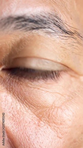 This close-up eye shows a warm brown iris, detailed and calm