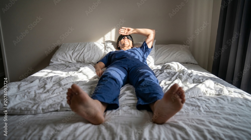 Obraz premium Foot Of Bed Portrait Of Nurse Battling Daylight After Night Shift