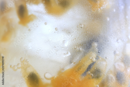 passion fruit lemonade background, cold lemonade in a glass, delicate texture cold tropical drink background