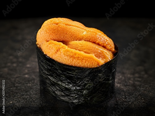Fresh sea urchin roe sushi on a black background