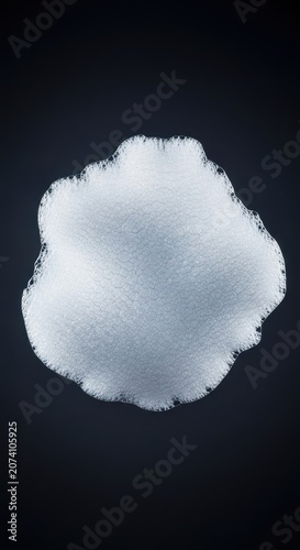 Thick, dense, white soap foam structure floating in isolation against a dark, featureless background, showing detailed bubbling texture, airy, pure, structure