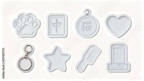 An organized set of white polymer clay molds featuring various shapes like paw prints, a star, and heart, alongside keychains and themed items, displayed on a bright background.
