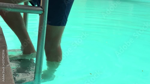 Video of a man swimming in a modern swimming pool. Healthy lifestyle and fitness concept representing physical activity, endurance, recreation and aquatic sports.