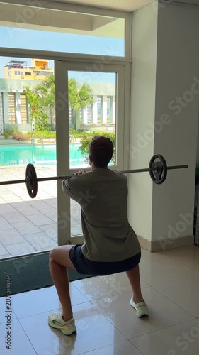 Video of a man performing dumbbell exercises in a modern gym. Fitness and strength training concept representing an active lifestyle, muscle building and personal health.