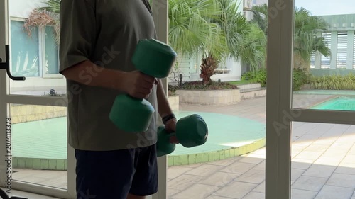 Video of a man performing dumbbell exercises in a modern gym. Fitness and strength training concept representing an active lifestyle, muscle building and personal health.