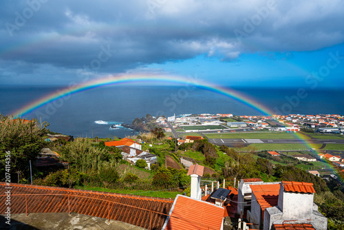 Landscape of the airport runway with a rainbow. Flores Island, Azores, Portugal.