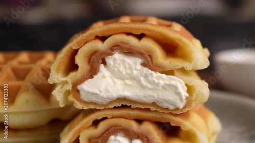 Sweet Crispy Waffles Filled with Fluffy White Cream on a Plate