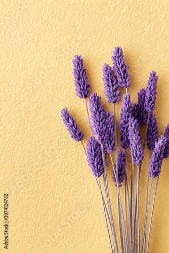 vertical overhead image of dried lavender on pastel yellow background, expressing warmth, simplicity, natural botanical beauty. Suitable for greeting cards, seasonal marketing, wellness advertising