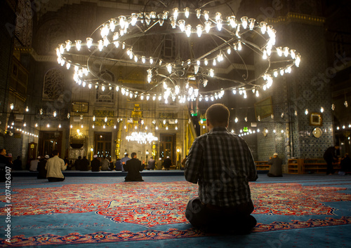Muslim men praying inside new mosque Yeni Camii, Marmara Region, istanbul, Turkey