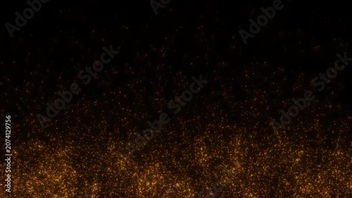 Golden glowing particles on a black background. 4K