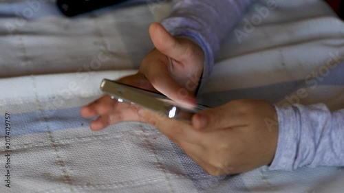 child's finger scrolling on a smartphone screen, symbolizing children's internet use, digital habits, online safety, parental control, and cybersecurity awareness in today's connected world