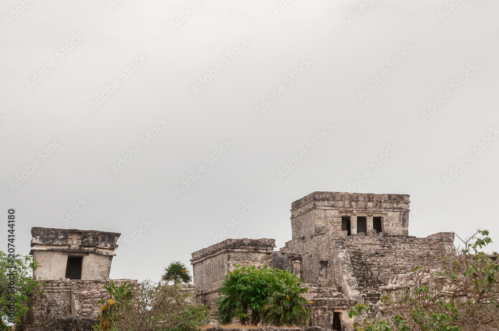Fototapeta premium Tulum archaeological ruins with Mayan pyramid and visitors Mexico