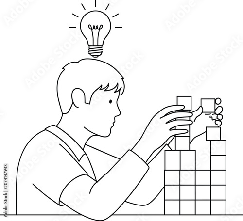 Boy building tower blocks lightbulb over head representing idea inspiration and creative thinking