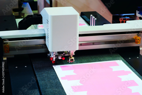 Fotografie Industrial machine precisely cuts material on a flat surface