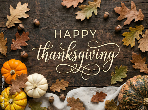 Vibrant autumn harvest celebration with handwritten Thanksgiving message surrounded by pumpkins, acorns, and maple leaves on rustic wooden background