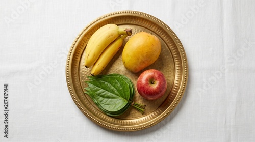 Traditional Fruit Platter On Brass Tray, Festive Offering Arrangement, White Linen Tablecloth, Elegant Commercial Food Styling, High Angle Studio Shot