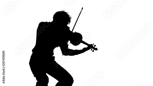 Silhouette of person playing golf swing on green field.