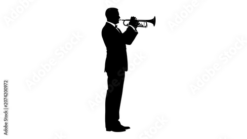 Solitary silhouette of a man holding a trumpet outdoors at dusk.