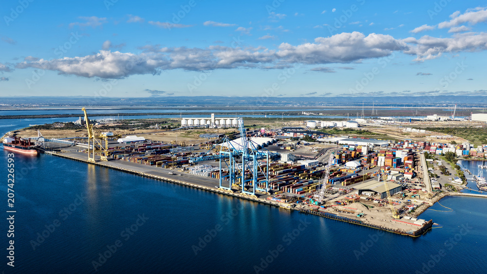 Obraz premium Outer Harbor, South Australia – 4K aerial drone view of Flinders Adelaide Container Terminal, container port, cargo terminal, shipping cranes, logistics hub, freight operations and industrial water