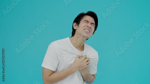 hand hold chest with heart attack symptoms, asian man have chest pain caused by heart disease, leak, dilatation, enlarged coronary heart, press on the chest with a painful expression
