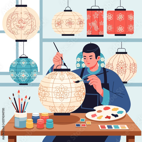 Artist hand painting traditional lantern with floral pattern, craft workshop