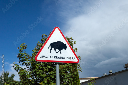 A road sign with an inscription in Polish, Attention: Land of the Bison