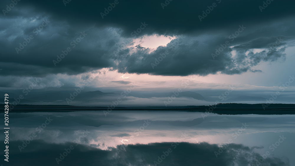 Obraz premium Dramatic Storm Clouds and Lightning Reflected on Calm Wilderness Lake Landscape