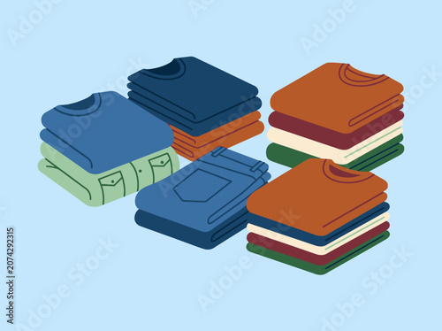 Foto Neatly folded piles of colorful clothes on a blue background