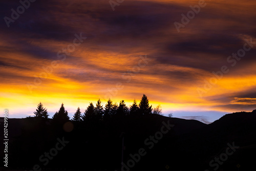 Silhouette of mountains and forests at dusk.
