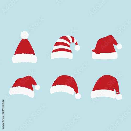 Photos A collection of red Santa Claus hats on a blue background