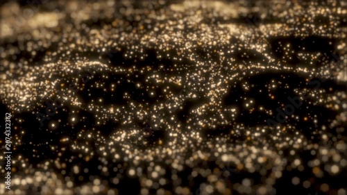 This is a stock motion graphic that shows gold particles on a black background.