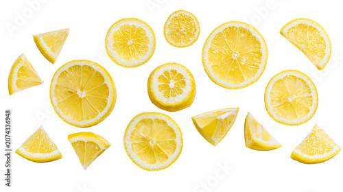 Photos Fresh yellow lemon slices and wedges scattered