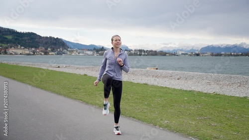 Young athletic woman warming up outdoors before running