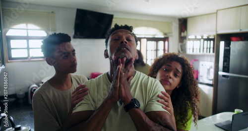Obraz na plátně Father covering face in stress as teenage son and daughter persist with requests