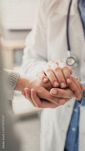 Compassionate doctor comforting patient during consultation