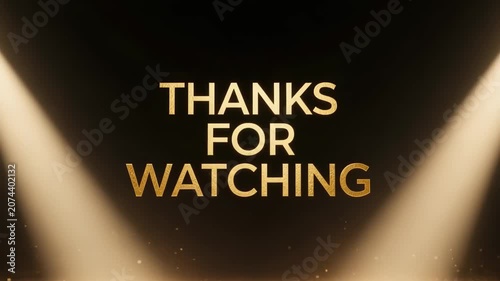 Thanks for watching text overlay in metallic gold font illuminated by two bright spotlights on a dark stage, cinematic end card for video content.