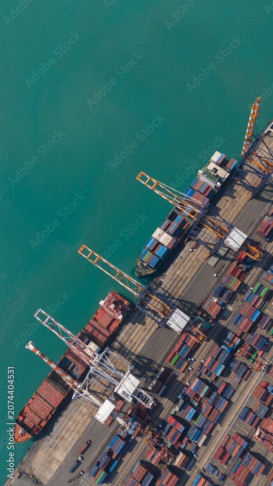 Fototapeta premium Aerial view from a container drone. Container ships in export-import and logistics business Transporting goods to large ports Worldwide shipping and logistics business International business abroad
