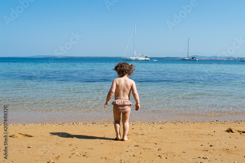 Toddler Sitting on a Sandy Adriatic Beach, Enjoying Summer by the Sea in Croatia