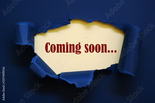 Coming Soon Message Revealed Through Torn Slate Blue Paper For Product Launch Marketing Announcement And Business Promotion Concept