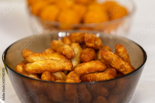 Golden brown crispy breadsticks served in a dark glass bowl for snacking