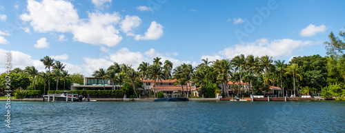Vacation building in summertime. Luxury waterfront house. Hotel building. Residential architecture. Modern building Miami. Residential apartment in waterfront city. Waterfront landscape with house