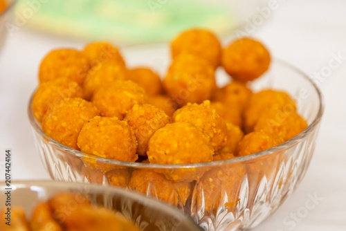 Delicious golden-orange sweets in a crystal bowl for festive celebrations