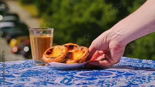 Pastel de nata egg tart served beside glass of meia de leite coffee on