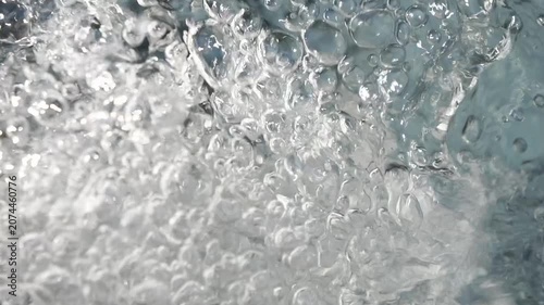 Bubbling water with air bubbles. Cavitation of water flow. Water texture.