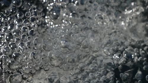 Bubbling water with air bubbles. Cavitation of water flow. Water texture.
