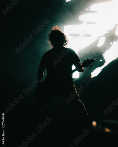 silhouette of man playing guitar