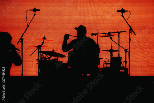 silhouette of a man playing the drums