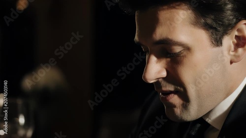 Caucasian male enjoying red wine in elegant setting, savoring the aroma and taste, captured in a series of close-up frames highlighting the experience