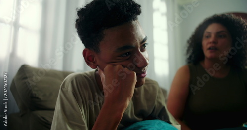Canvas Print Teenage boy appearing disengaged and distant as mother attempts to engage, highl